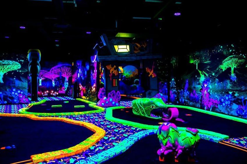 A neon-lit indoor scene with a winding path, glowing plants, and a dinosaur model. 5