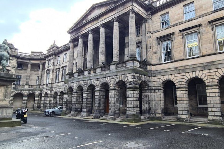 A historic building with classical architecture, including columns and arched windows. 5