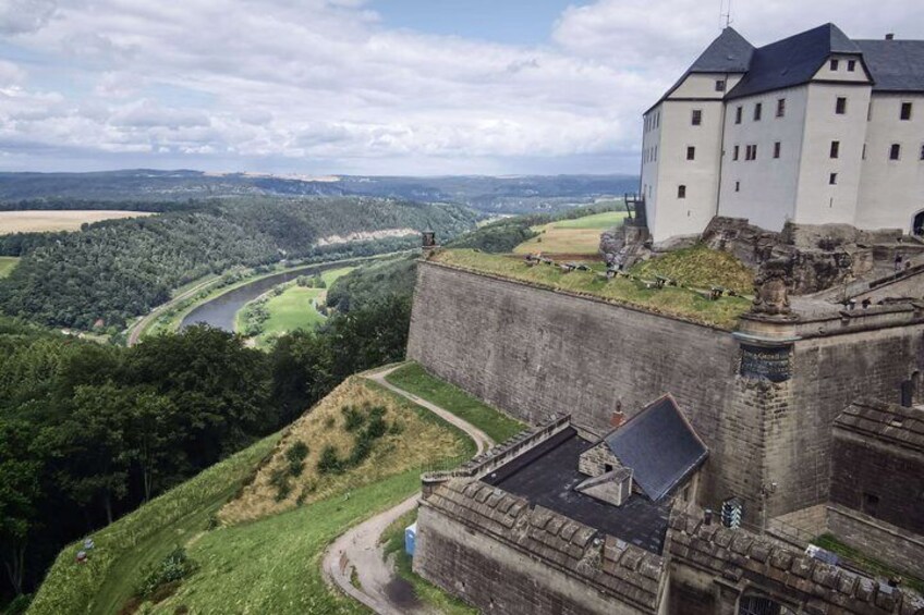 A castle on a hill overlooking a river and valley. 1