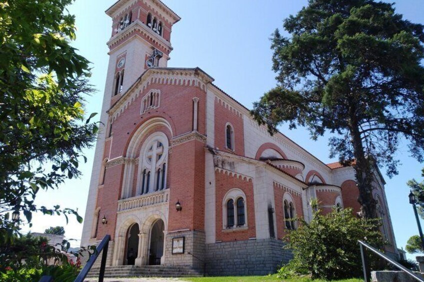 A red brick church with a bell tower and arched windows. 4