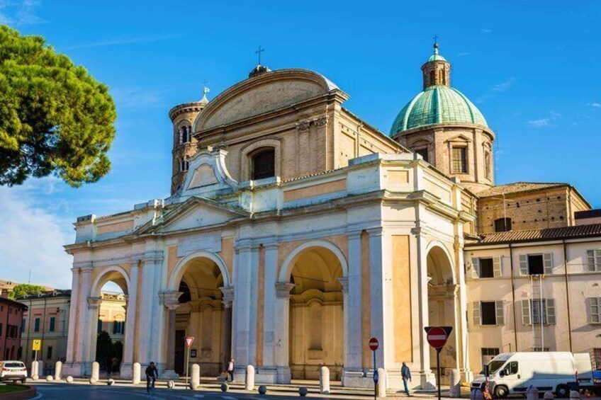 A historic church with a dome and arches. 3