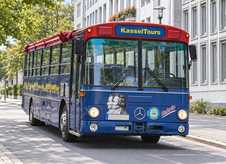 A blue double-decker bus with 'KasselTours' and 'Cabrio' branding, parked on a city street. 3