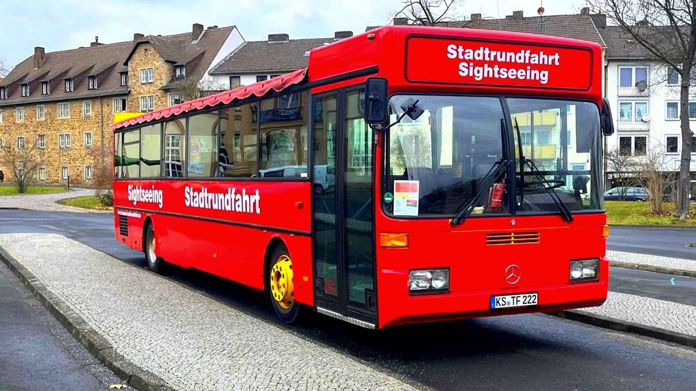 A red city sightseeing bus with 'Stadtverkehr Sightseeing' written on the side. 4