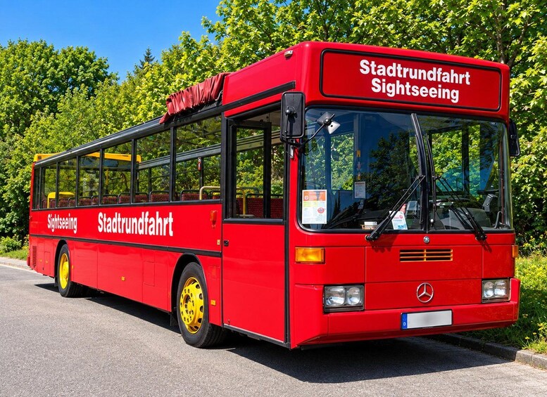 A red city sightseeing bus with 'Stadtverkehr' and 'Sightseeing' written on its side. 2