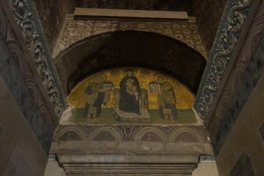 A mosaic with religious figures, an arched ceiling, and ornate wall decorations. 3