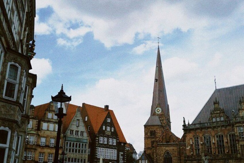 A church with a tall spire, traditional European architecture, and a clear sky. 2