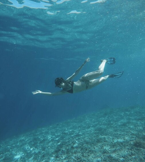A person swimming underwater. 2