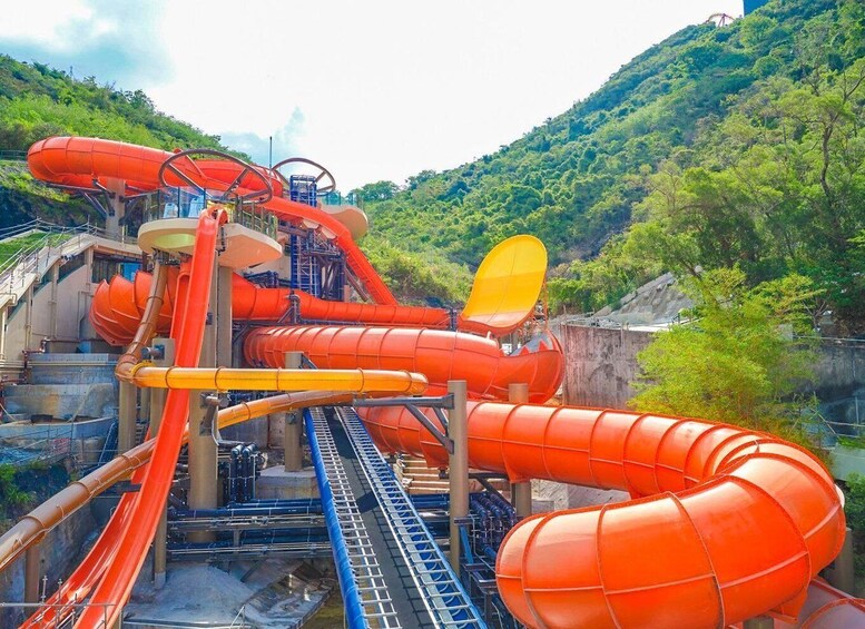 A water park with multiple water slides and a mountainous backdrop. 5