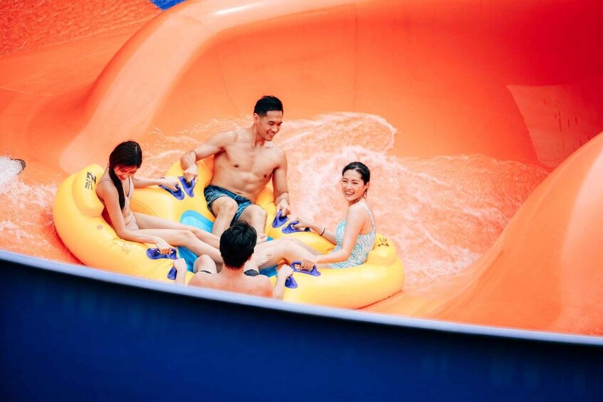 People on inflatable rafts in a water slide. 2