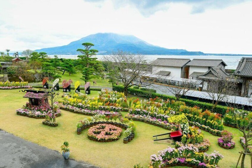 A traditional Japanese garden with a variety of flowers, a pond, and a mountain in the background. 4