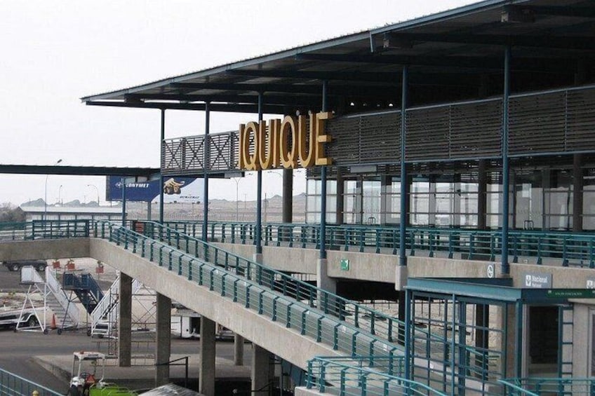 A stadium with a sign that reads 'QUOQUE' and a staircase leading to the seating area. 5