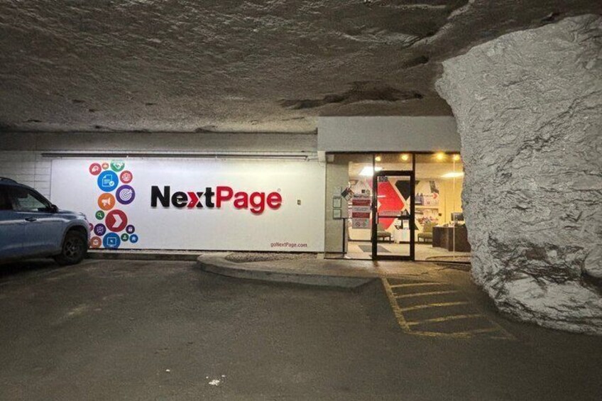 A parking garage entrance with a 'NextPage' sign and a car parked inside. 1