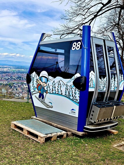 A ski lift cabin with a skier illustration, number 88, and the text 'LENK BETELBERG' on the side. 3