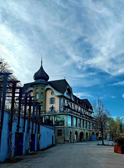 A large, historic building with a distinctive tower and multiple balconies. 5