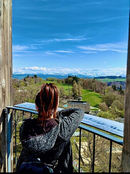 A person overlooking a scenic landscape with mountains and a clear sky. 2