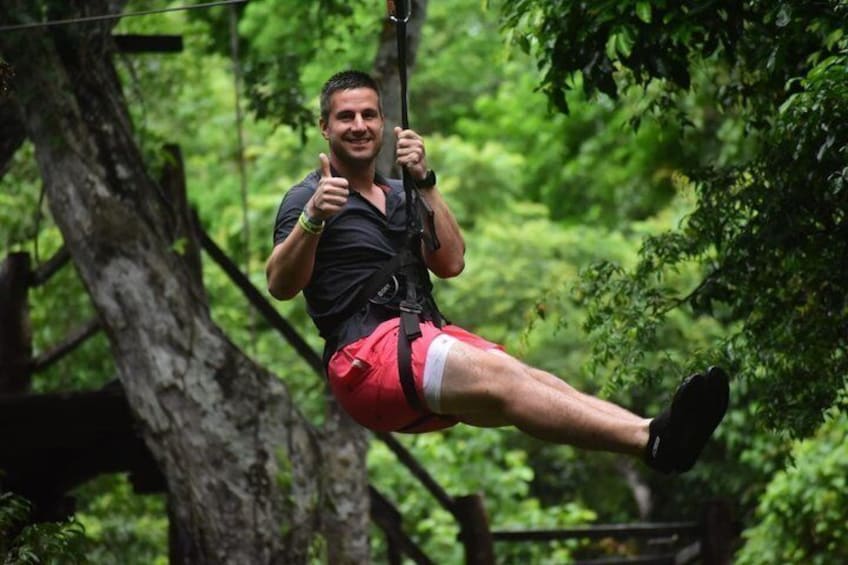 A person zip-lining through a forest. 5