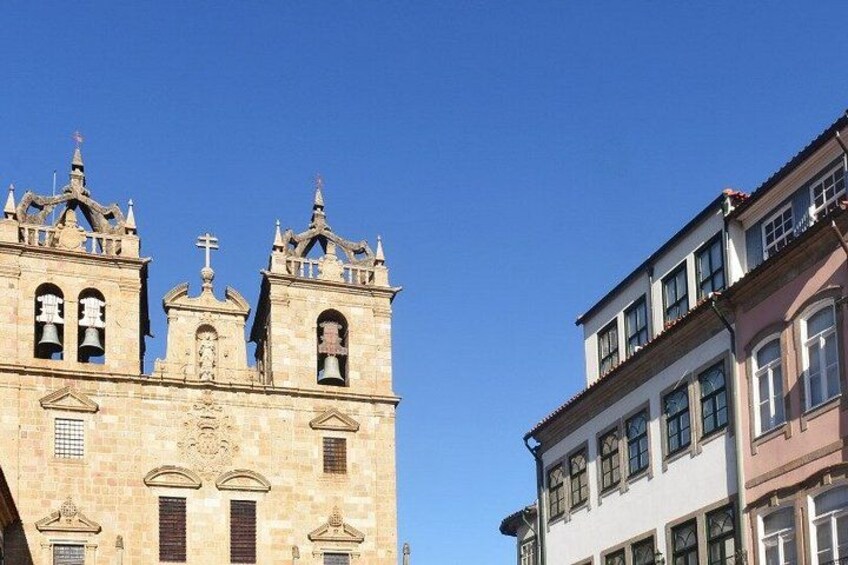 A historic church with two bell towers and a modern building adjacent to it. 5