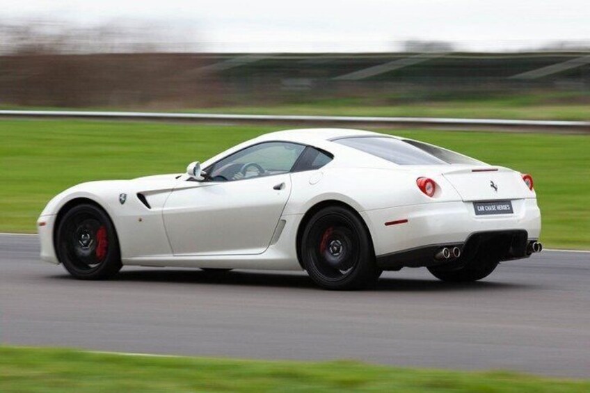 A white sports car on a racetrack. 3