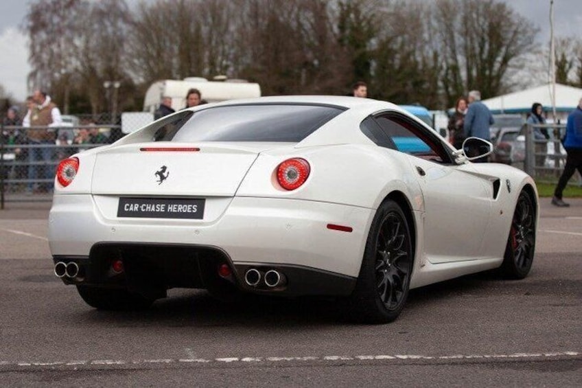 A white sports car with a Ferrari logo, a license plate reading 'CAR-CHASE HEROES', and a rear spoiler. 5