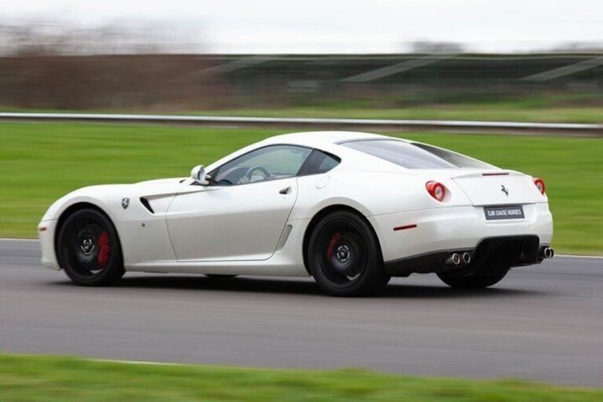 A white sports car on a racetrack. 3