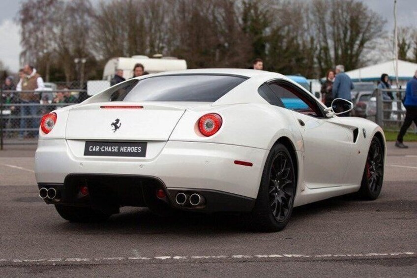A white sports car with a Ferrari logo, a license plate reading 'CAR-CHASE HEROES', and a rear spoiler. 4