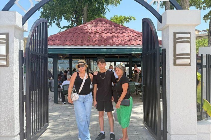 A gated entrance with a covered area and people standing in front. 5