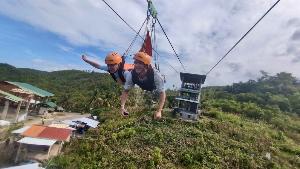Two people bungee jumping from a high platform. 3