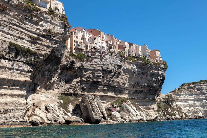 A coastal town built on a cliff with buildings perched on the edge. 5