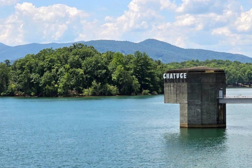 A water tower labeled 'CHATUGE' on a body of water with a forested island and mountains in the background. 1