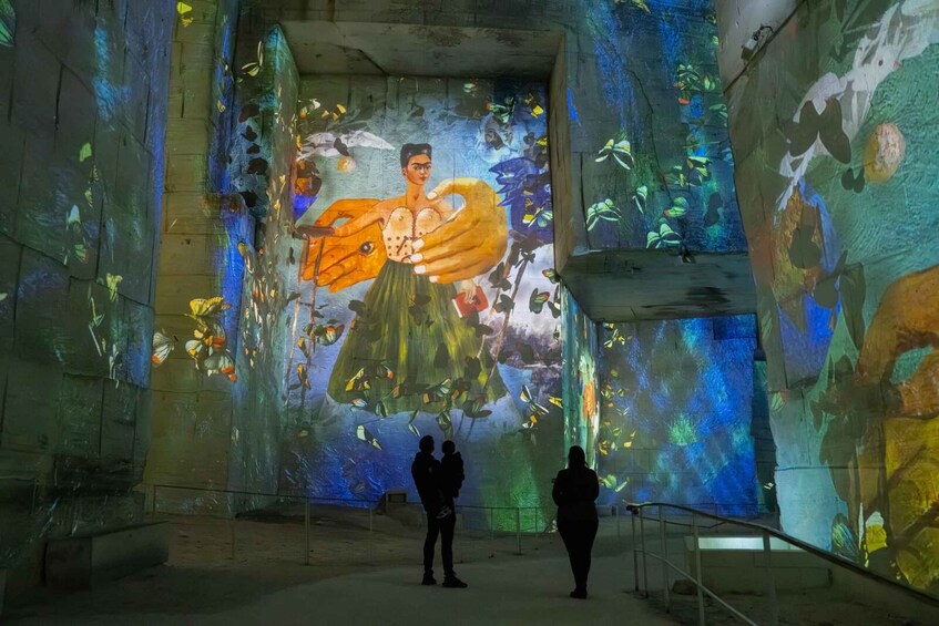 A large mural with a central figure holding a butterfly, surrounded by vibrant colors and patterns. 3