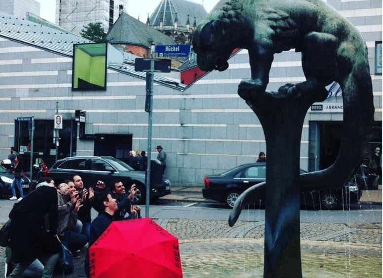 A sculpture of a dog on a pedestal, a street sign, a car, and a building with a dome. 5