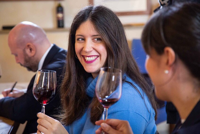 A person holding a wine glass. 1