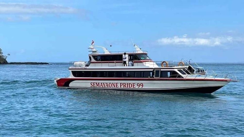 A boat named SEMAYAONE PRIDE 99 on the water. 1