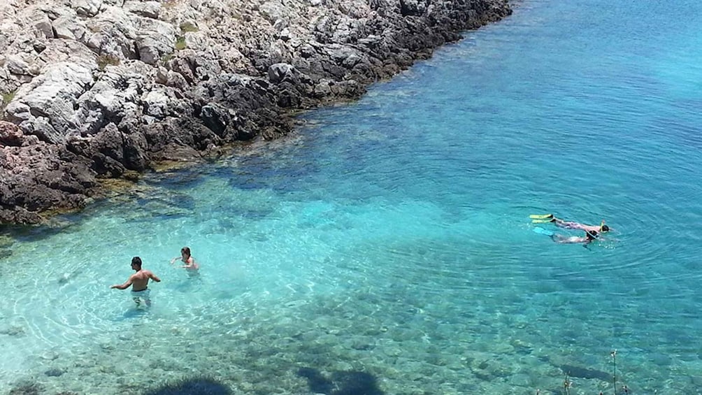 A rocky shoreline with clear blue water. 5