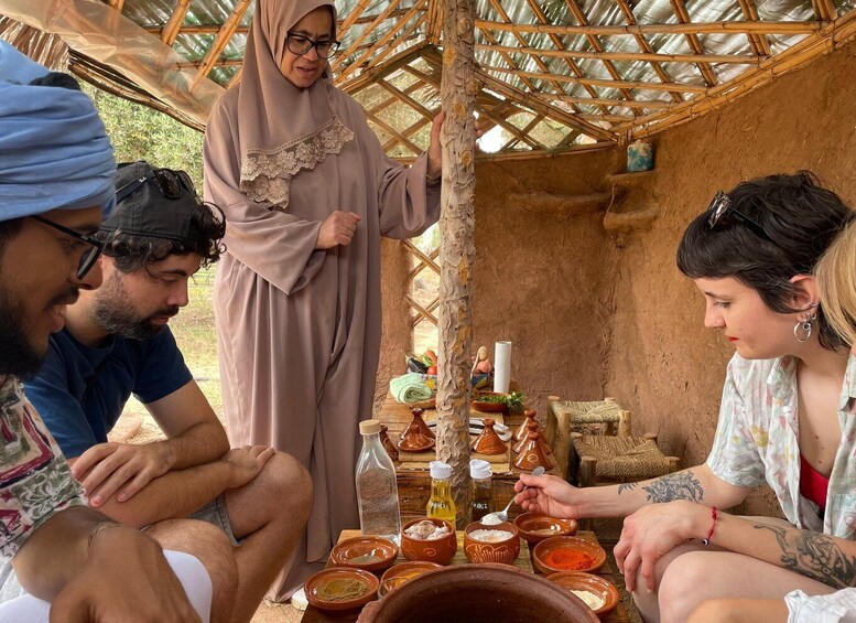 A group of people gathered around a table with various bowls and containers, possibly for a cooking or food preparation activity. 4