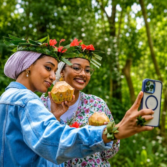 Two individuals taking a selfie in a lush green forest. 4