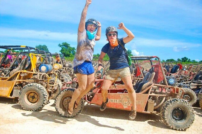 Two people jumping in front of off-road vehicles. 3