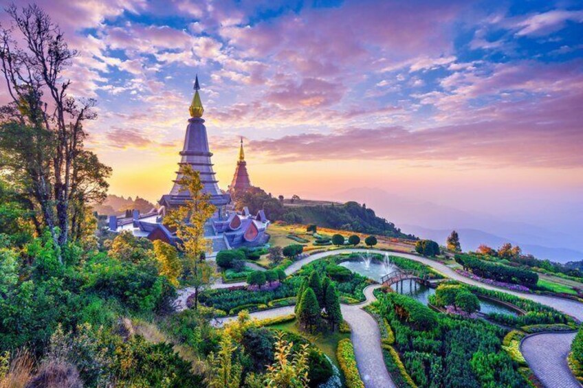 A temple complex with tiered roofs, surrounded by lush greenery and a winding pathway. 1