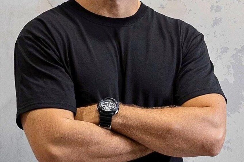 A person wearing a black t-shirt and a black wristwatch. 3