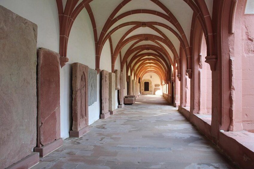 A corridor with arched ceilings and stone walls. 4
