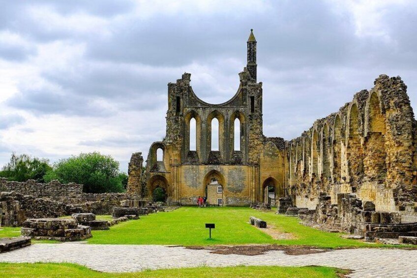 An ancient stone church with arched windows and a central tower. 1
