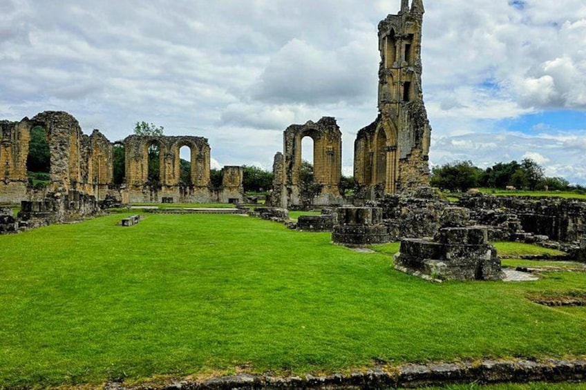 A historic ruin with arches and a tall tower. 2