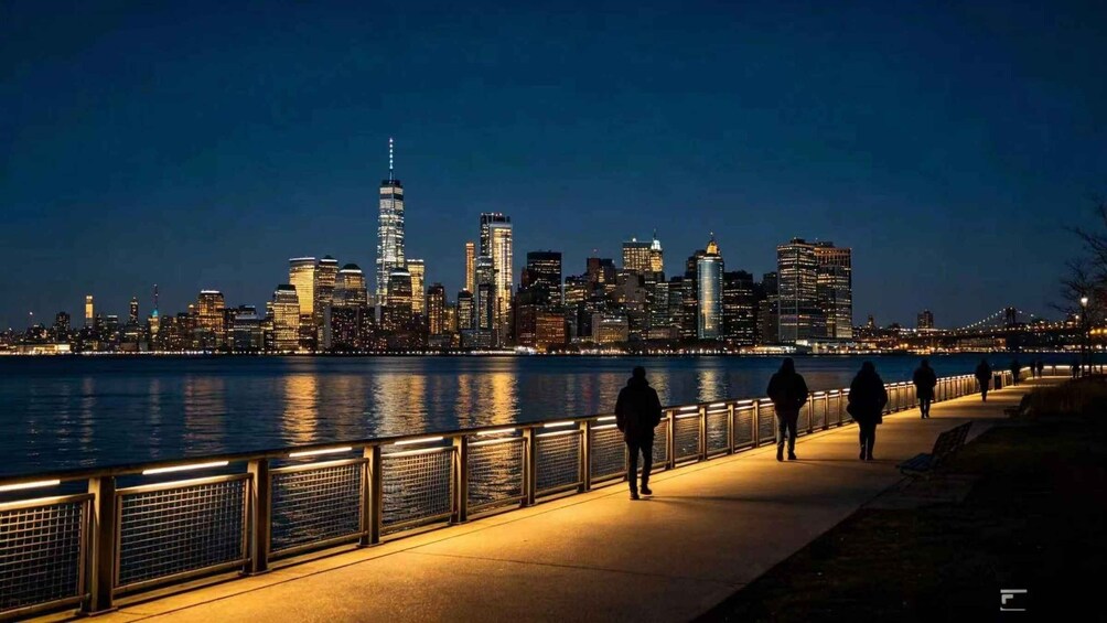 A nighttime city skyline with illuminated buildings along a waterfront promenade. 5