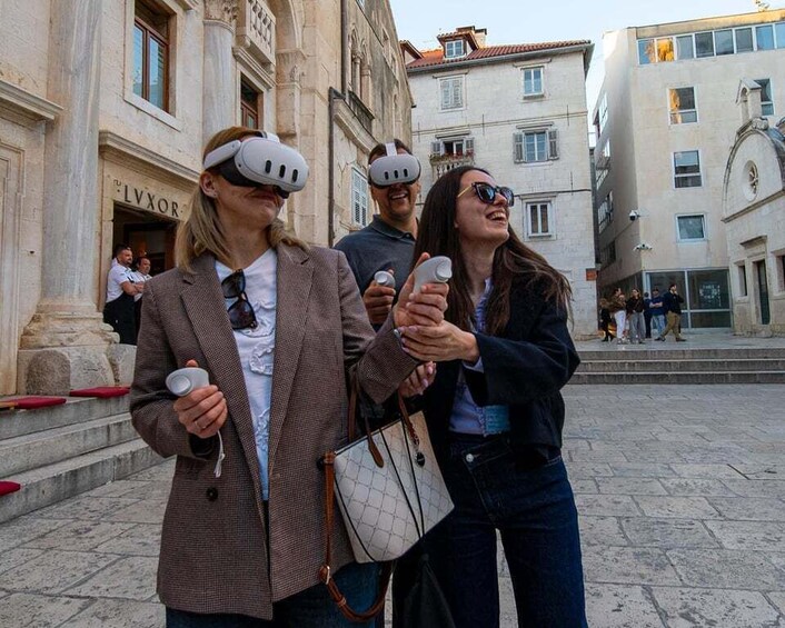 People wearing VR headsets in an urban square with historic buildings. 1