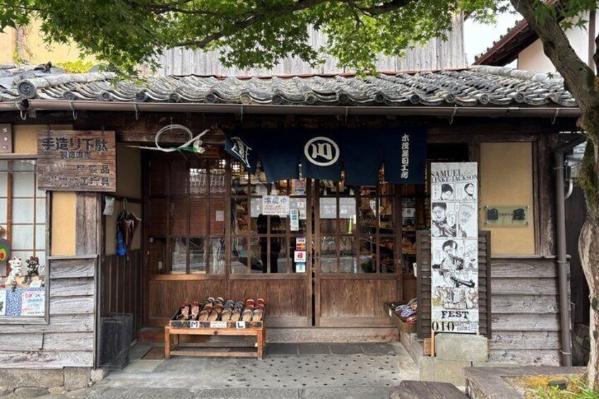 A traditional Japanese shop with wooden doors and a tiled roof. 4
