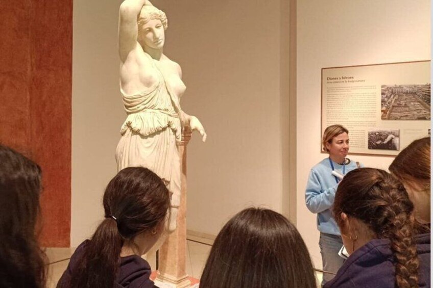 A marble statue of a woman in a museum. 1