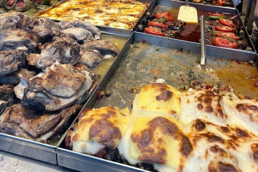 A variety of grilled meats and vegetables on a tray. 2