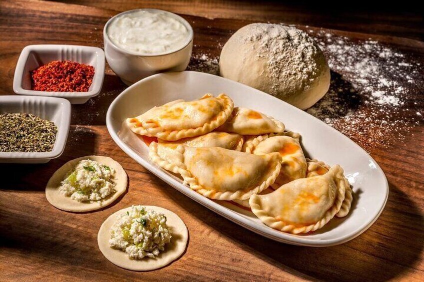 A plate of ravioli with various sauces and spices. 1