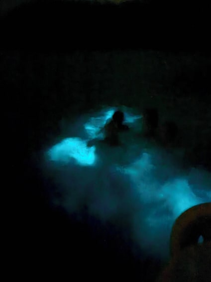 A person in a hot spring with steam rising around them. 3