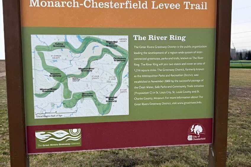 A signboard with a map and text about the Monarch-Chesterfield Levee Trail and The River Ring. 5